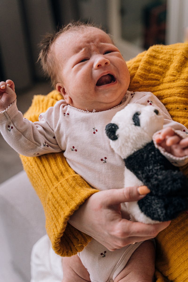 A Baby in a Onesie Crying