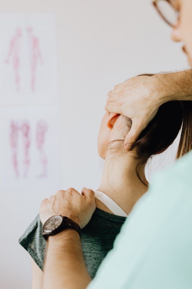 Professional Massage Therapist Treating a Female Patient's Injured Neck