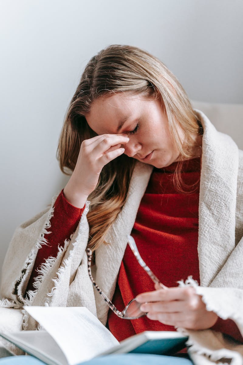 Woman Touches her Head in Pain