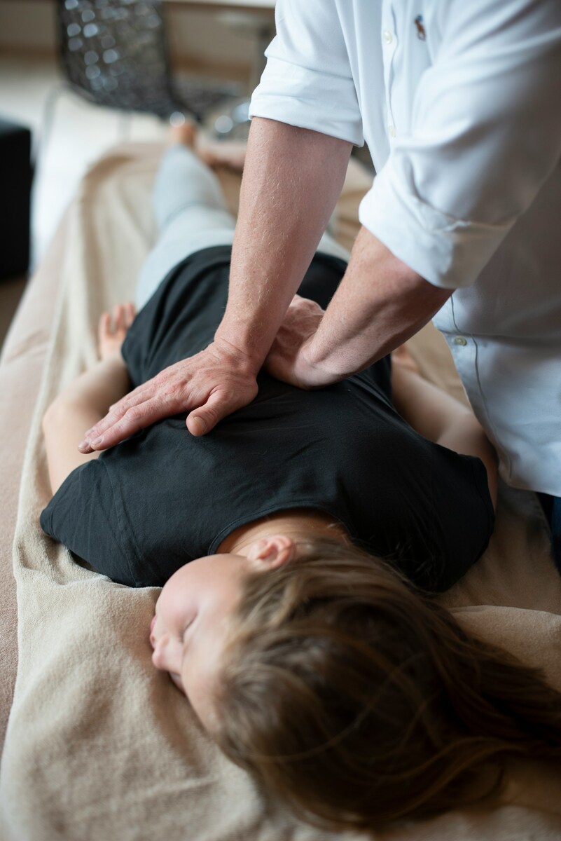 A woman getting a back massage from a man photo