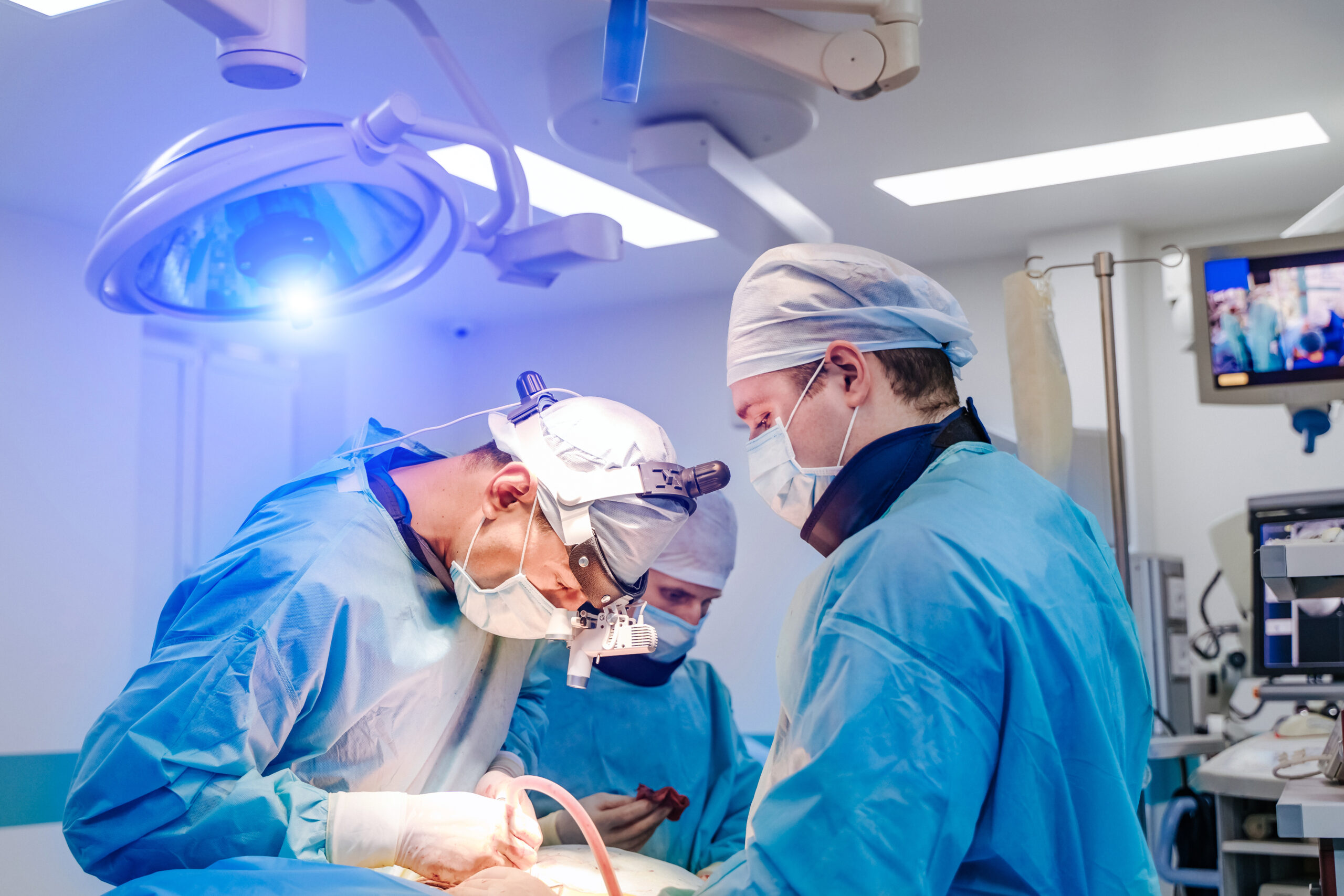Spinal surgery. Group of surgeons in operating room with surgery equipment. Laminectomy. Modern medical background