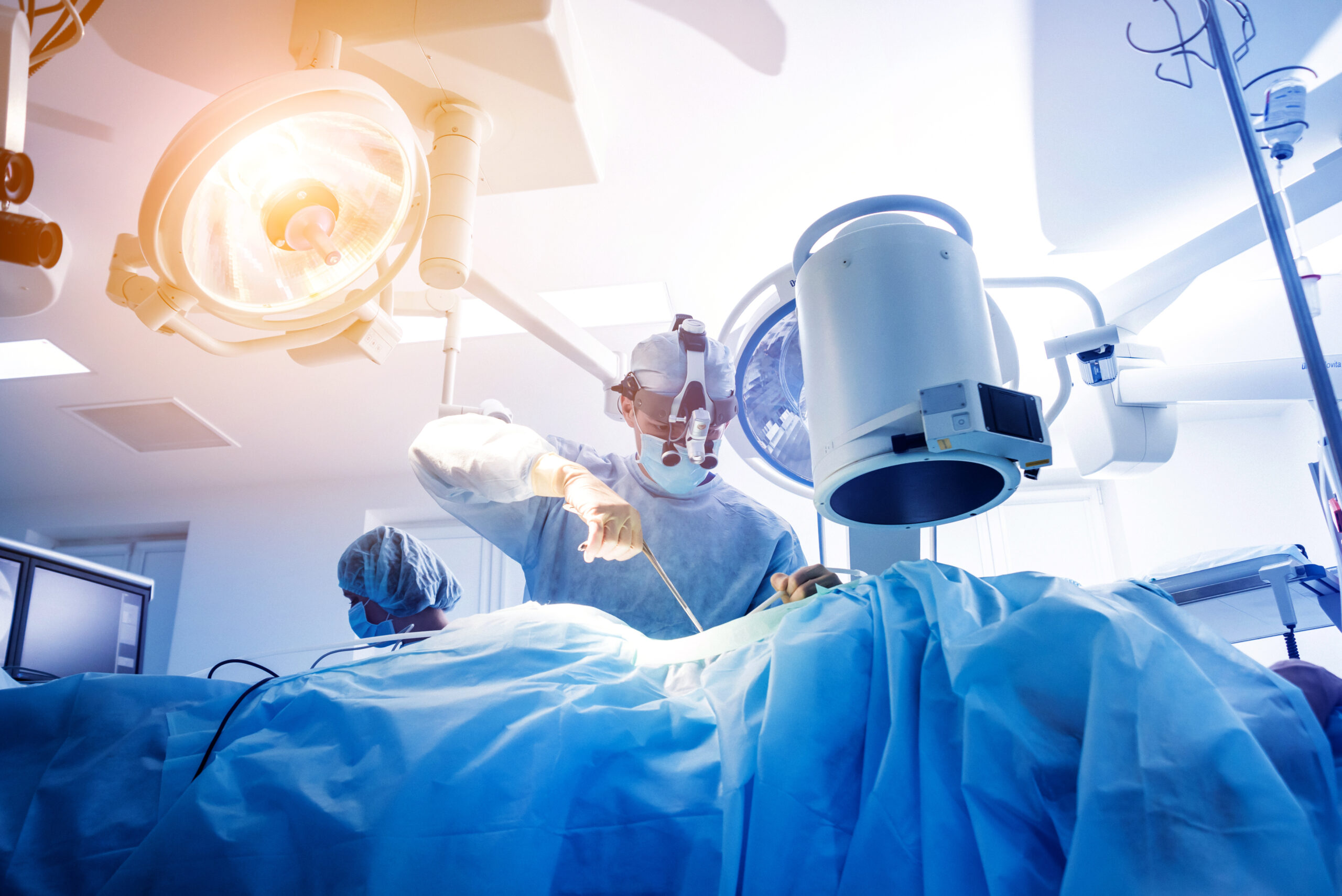 Spinal surgery. Group of surgeons in operating room with surgery equipment. Laminectomy. Modern medical background