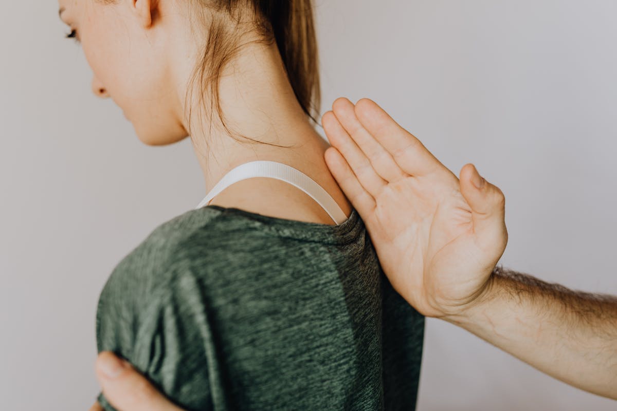 A professional chiropractor assisting a patient with spine alignment therapy.
