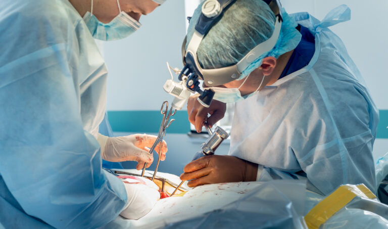 Spinal surgery. Group of surgeons in operating room with surgery equipment. Laminectomy. Modern medical background