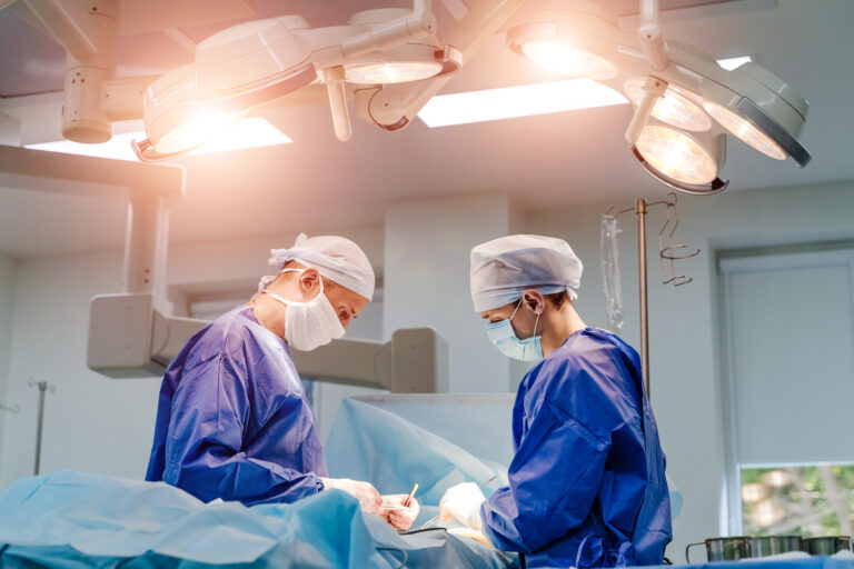 Spinal surgery. Group of surgeons in operating room with surgery equipment. Laminectomy. Modern medical background